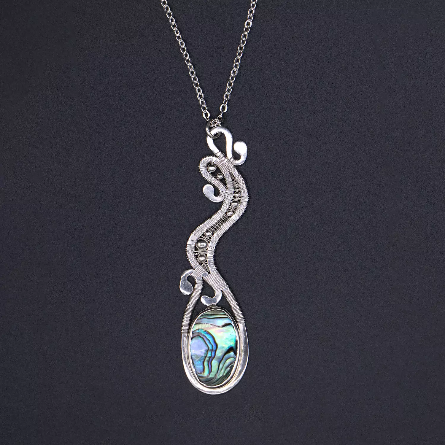 Silver necklace with abalone shell and silver balls. image