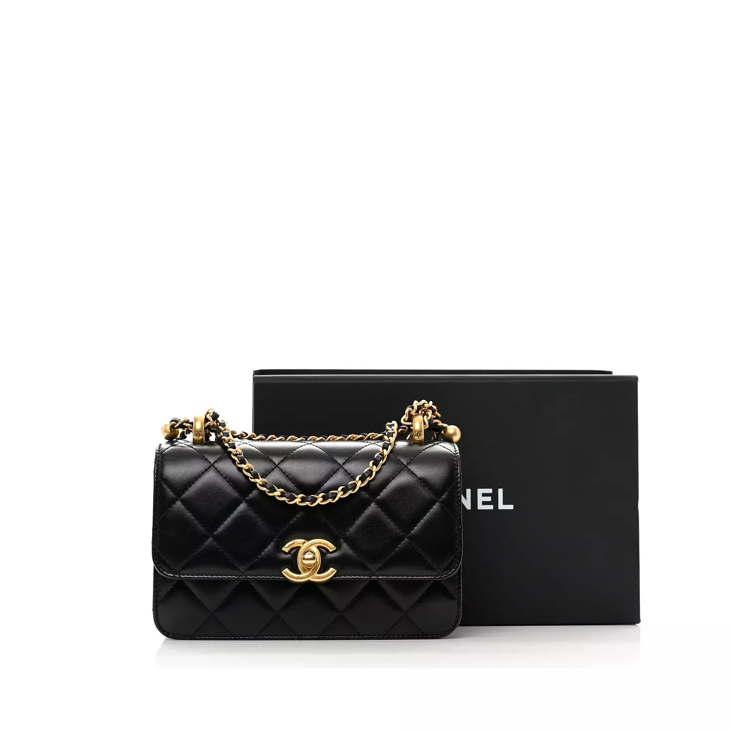 Chanel Small Flap Bag in black shiny calfskin leather features gold-tone meta 4