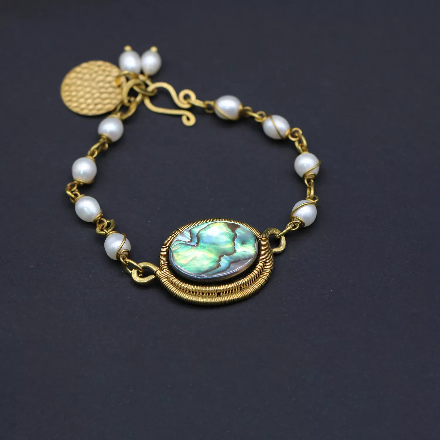Brass bracelet with abalone shell and pearls. image