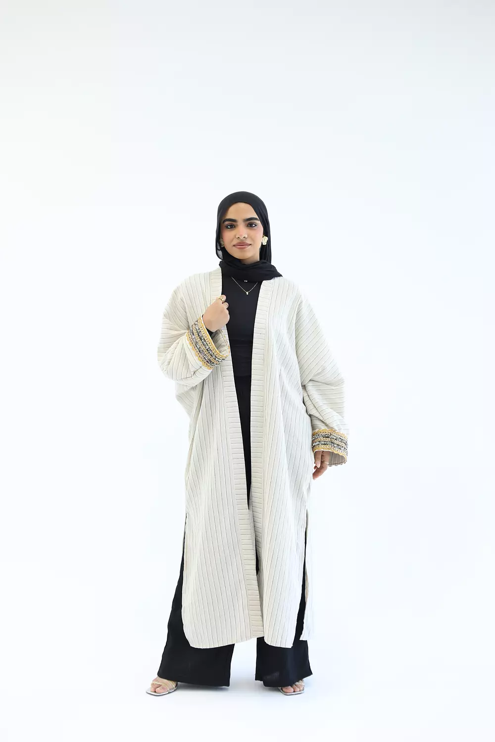 Striped cardigan with gold bracelet hover image