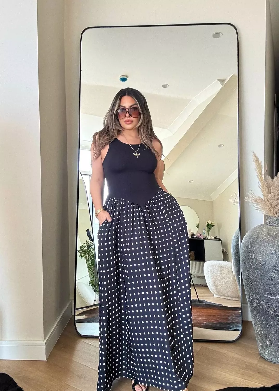 Black sleeveless polka dress image