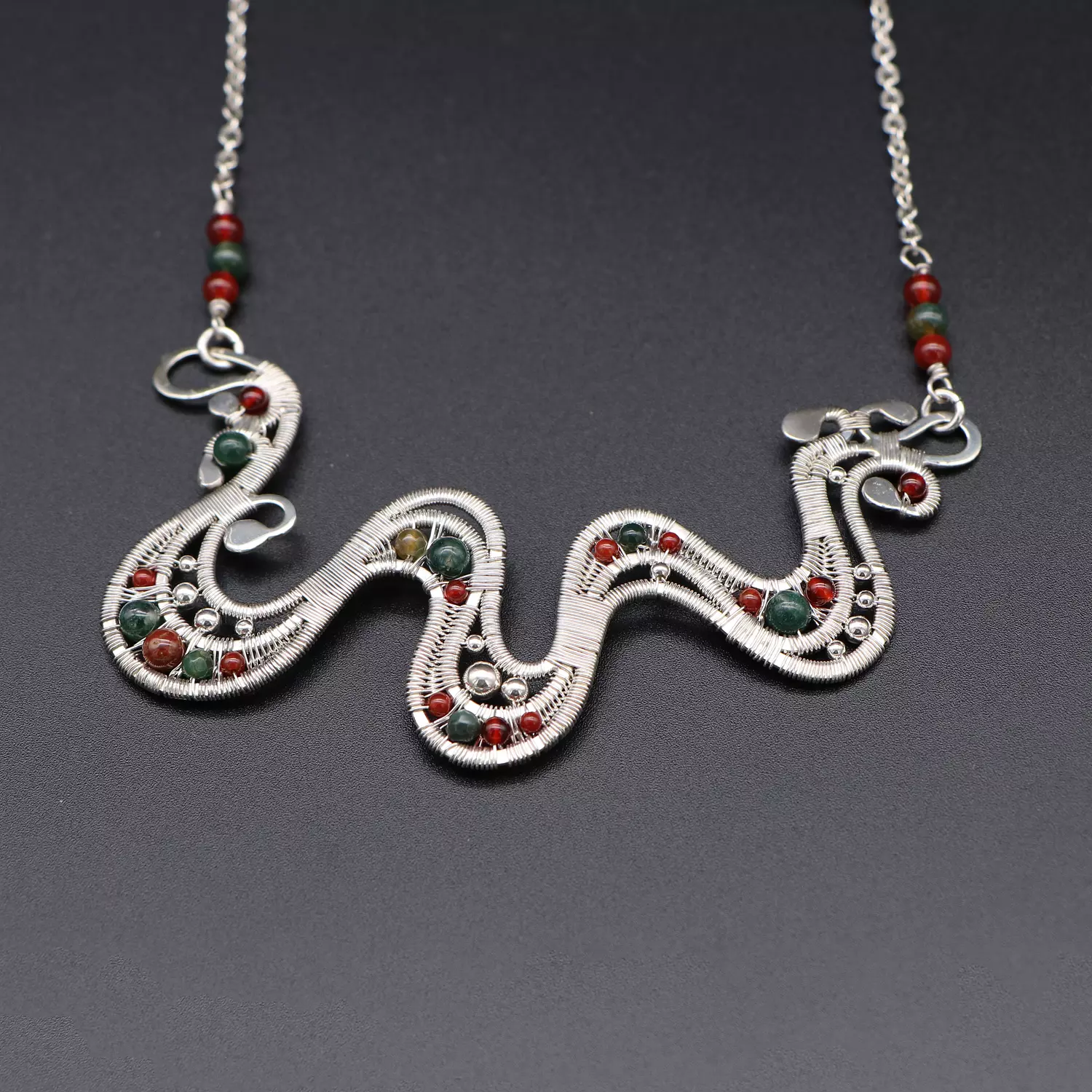 Wire wrapped silver necklace with moss agate gemstones. image