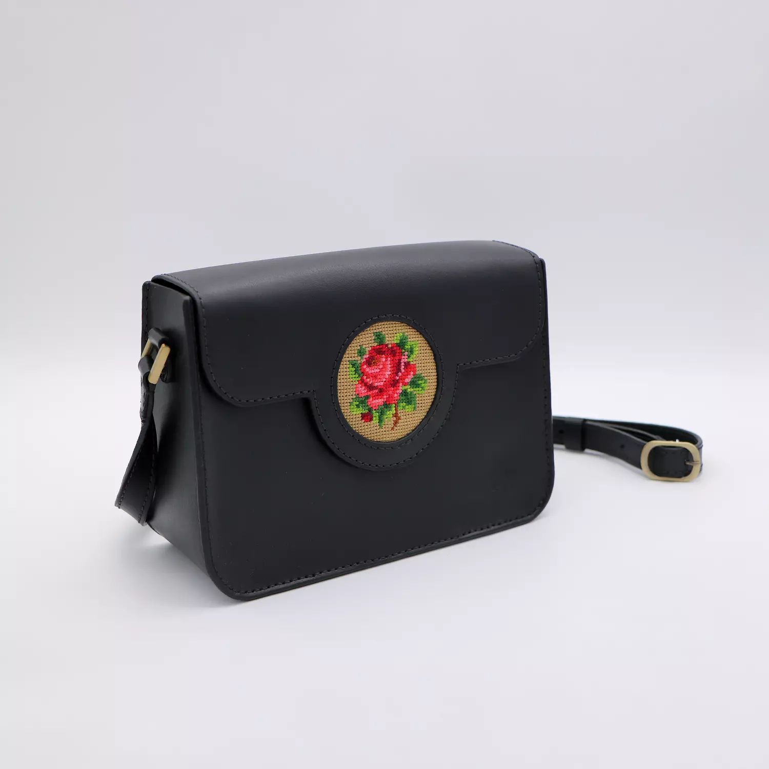 Black genuine leather bag with floral design. 1