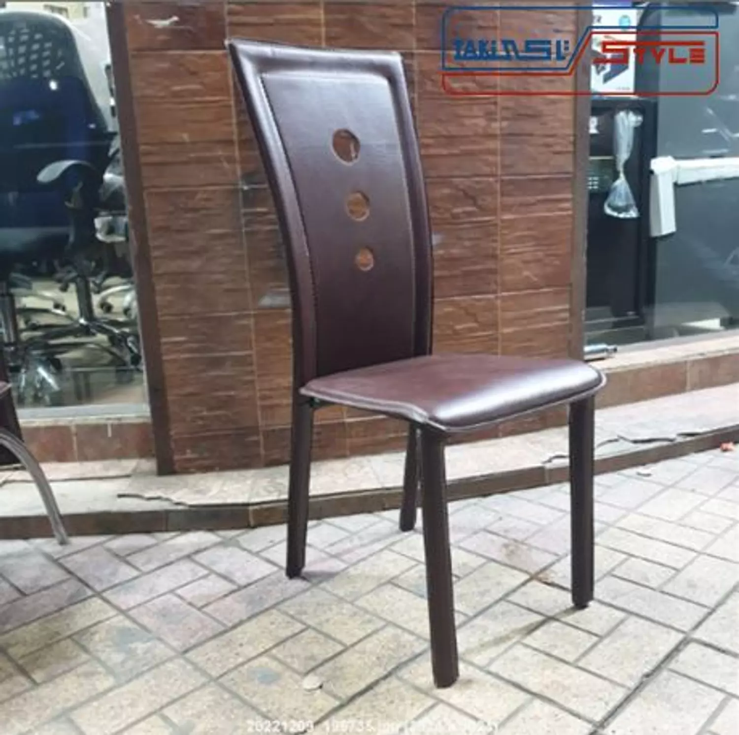 Brown leather dining chair with rounded back and leather legs