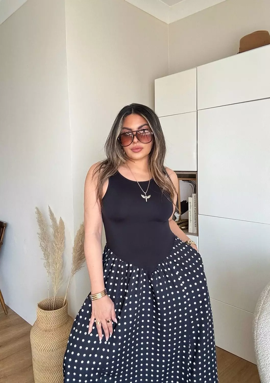 Black sleeveless polka dress hover image
