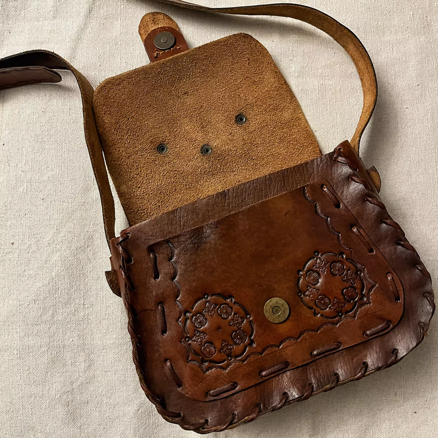 Bouquet tooled leather bag - scalloped border straps hover image