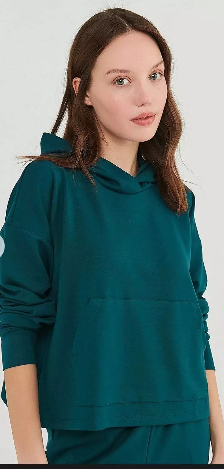 A modern, oversized women's hoodie with a clean, minimalist design. image