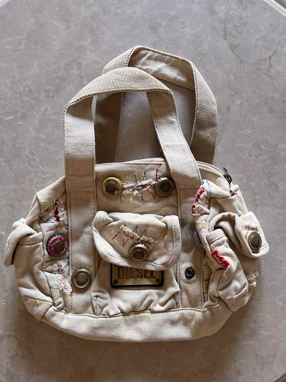 Beige ribbed diesel bag with adjustable buttons  image