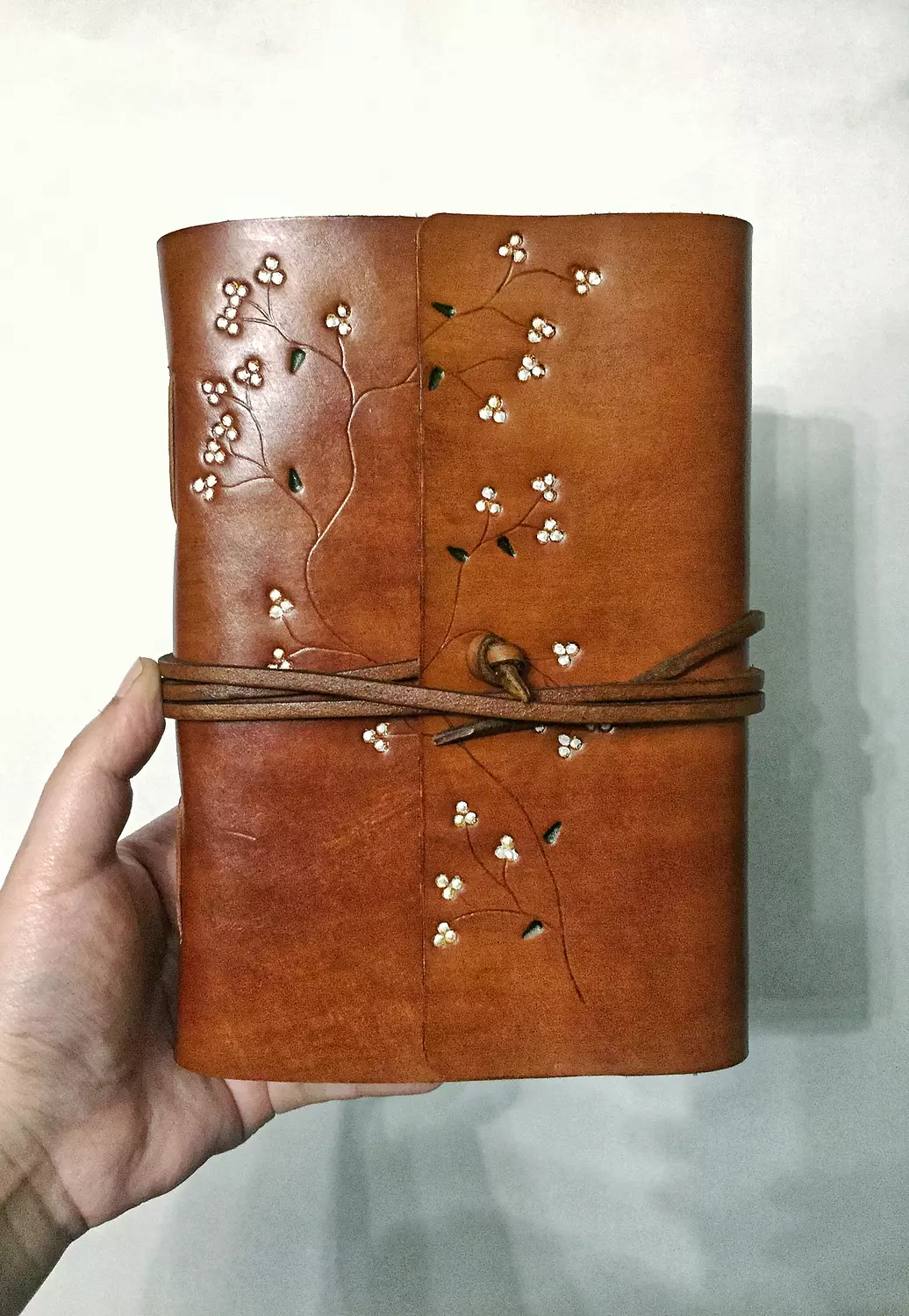 Tooled painted blossom vines leather journal with wraparound tie strap image