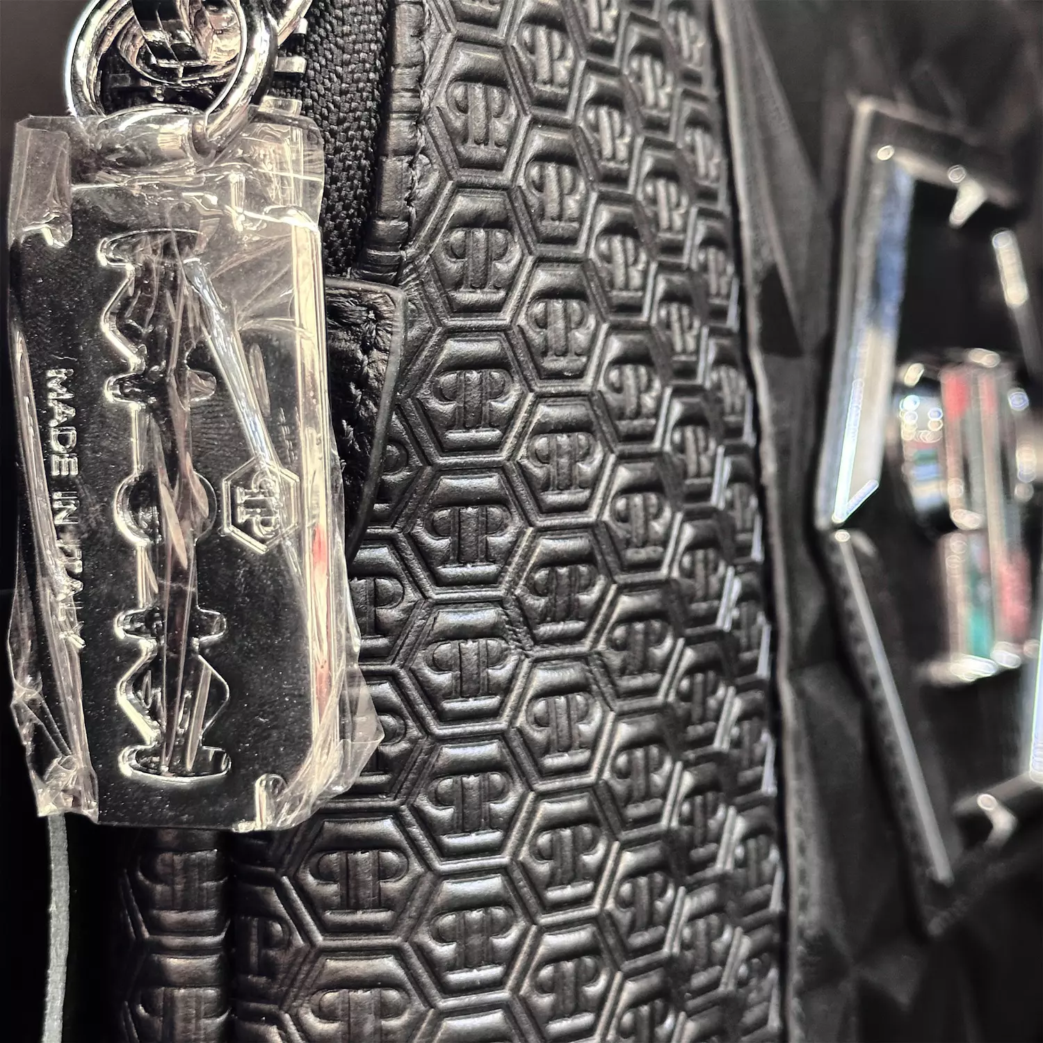 Philipp Plein clutch bag featuring a prominent metallic hexagon logo 2