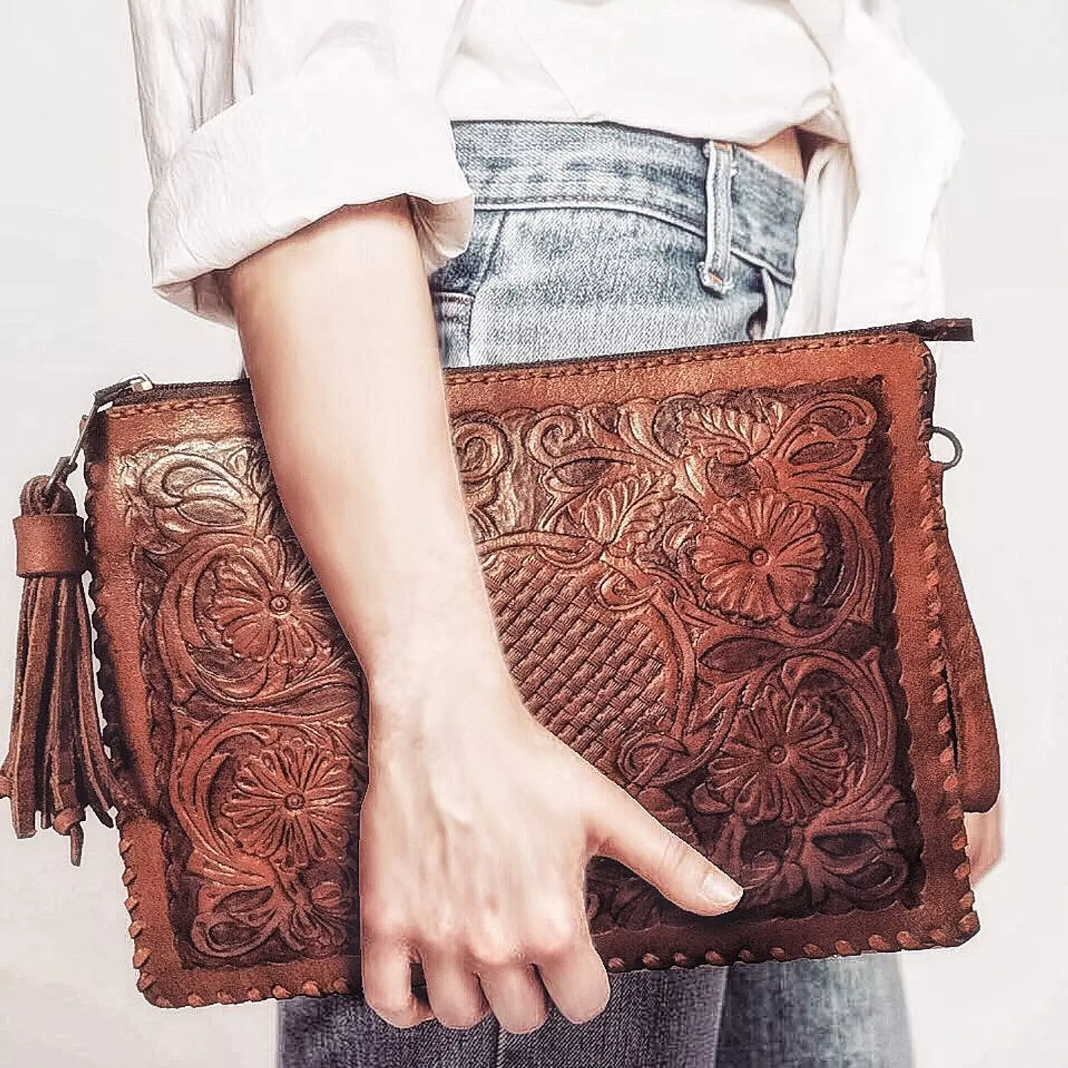 Floral basket tooled leather clutch image
