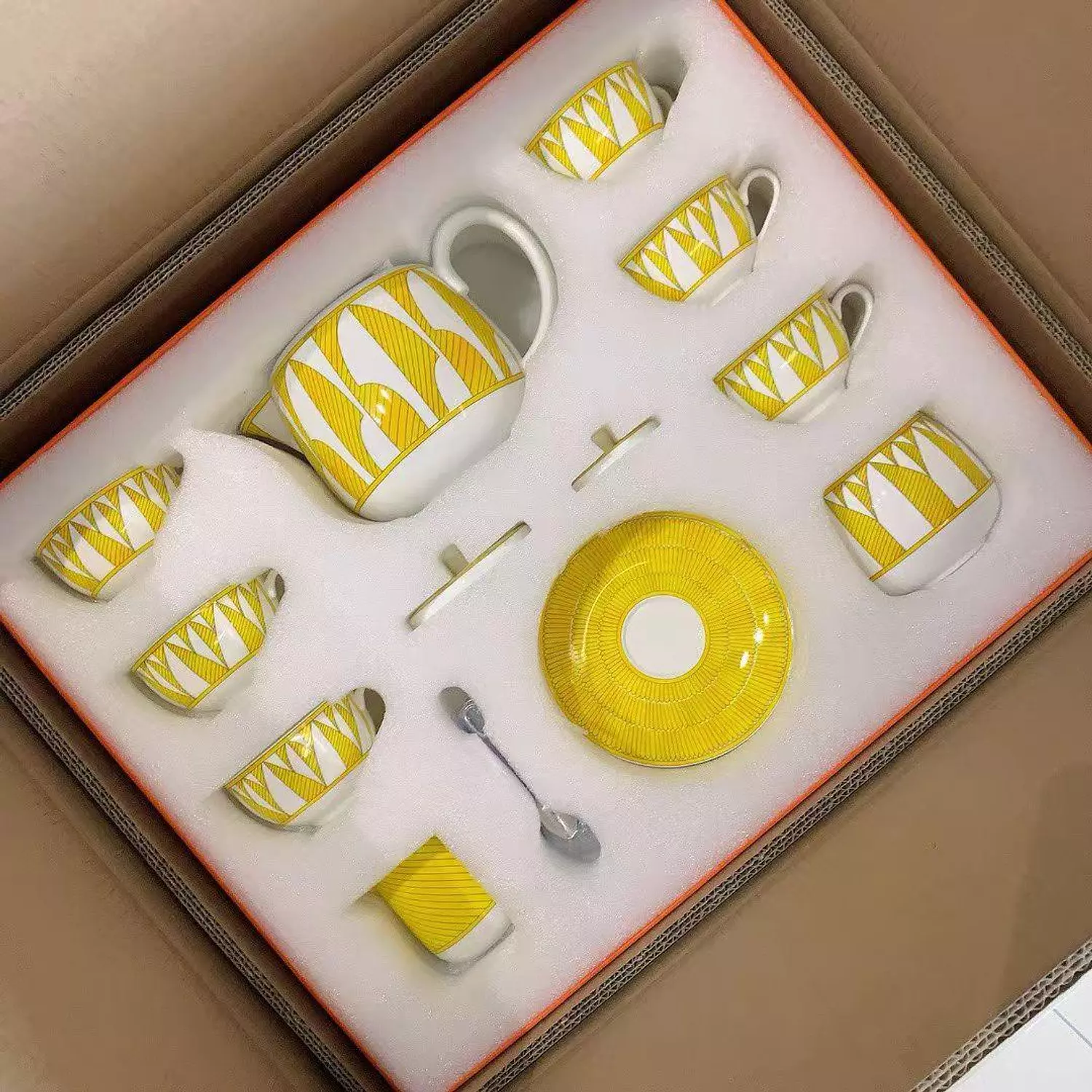Hermès Soleil d'Hermès porcelain tea set in a bright yellow and white pattern hover image