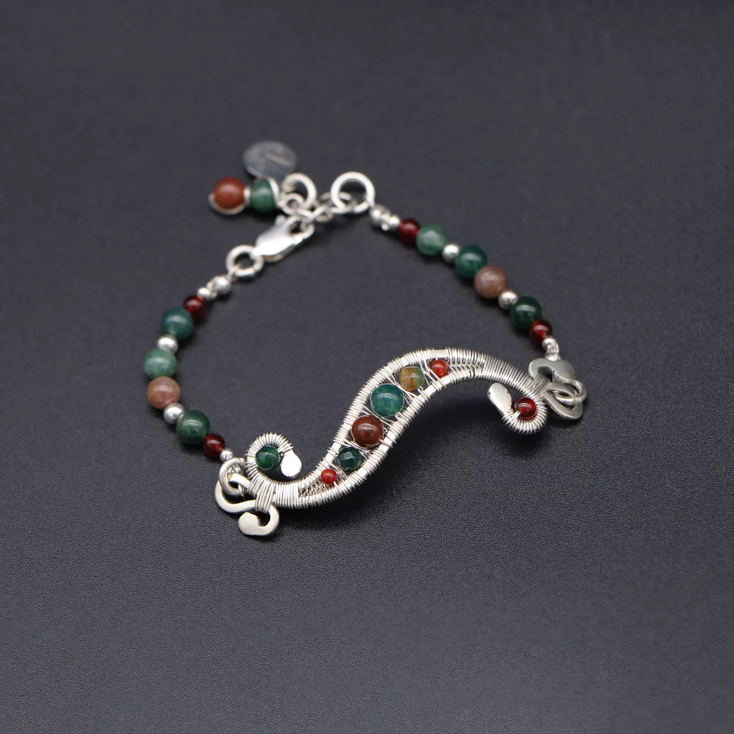 Wire wrapped silver bracelet with moss agate gemstones. 1