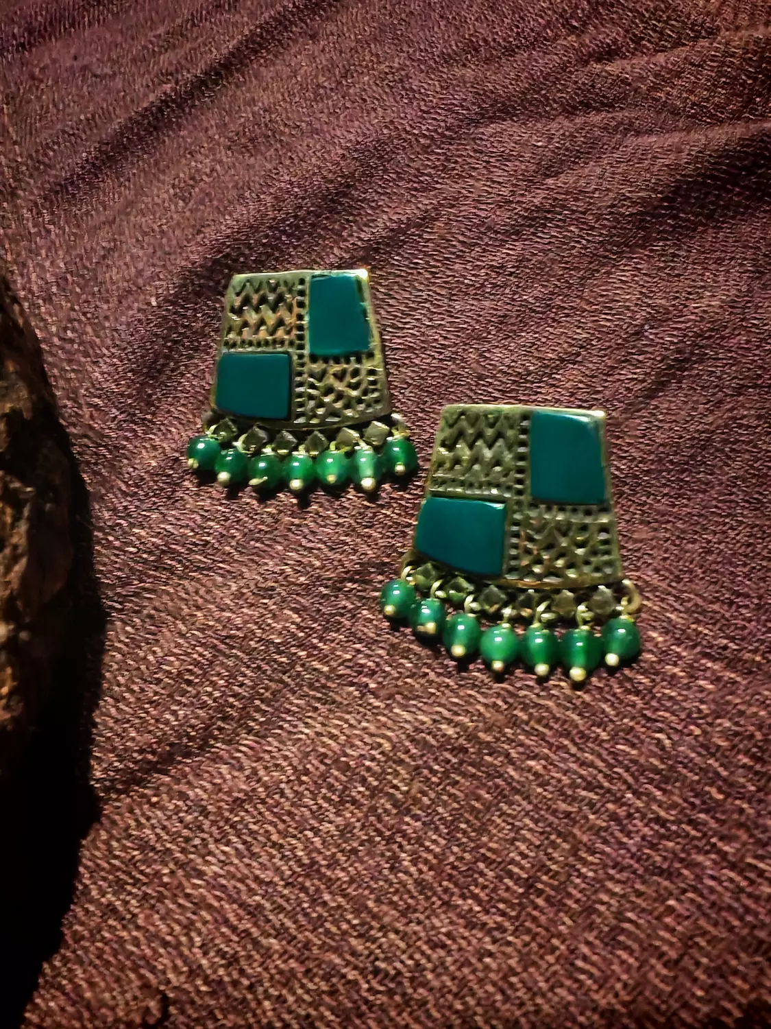 Brass earrings with green stones hover image