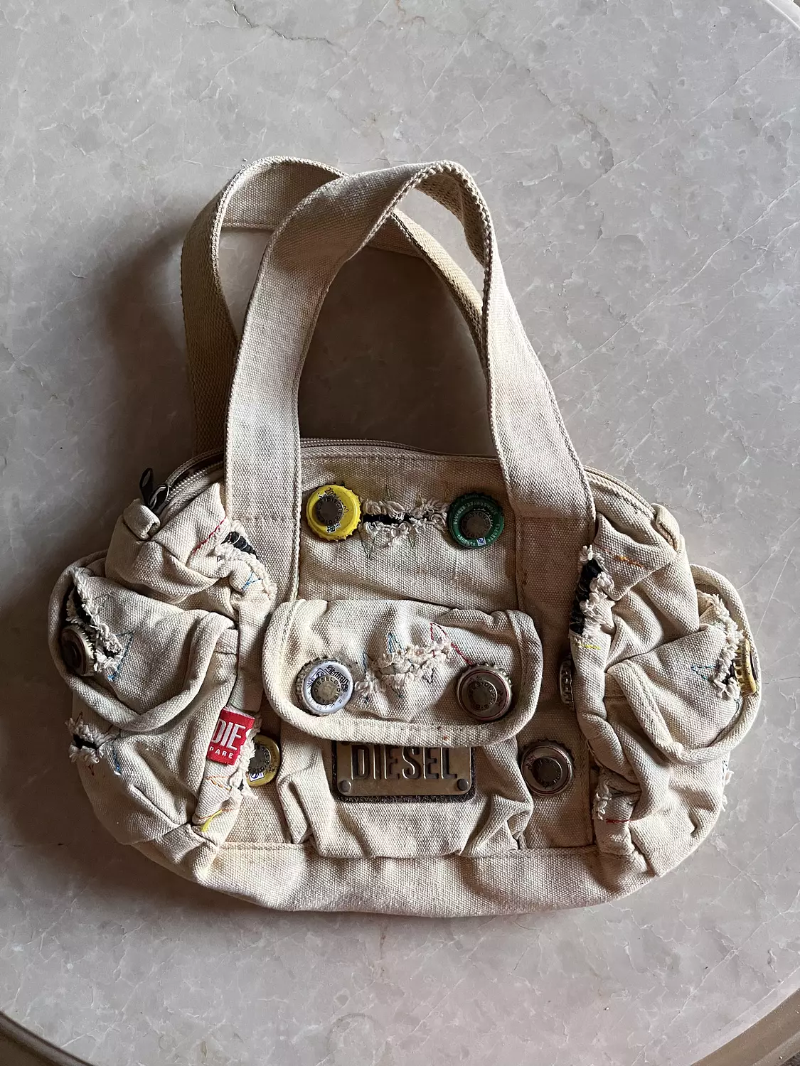 Beige ripped diesel bag with adjustable buttons  image