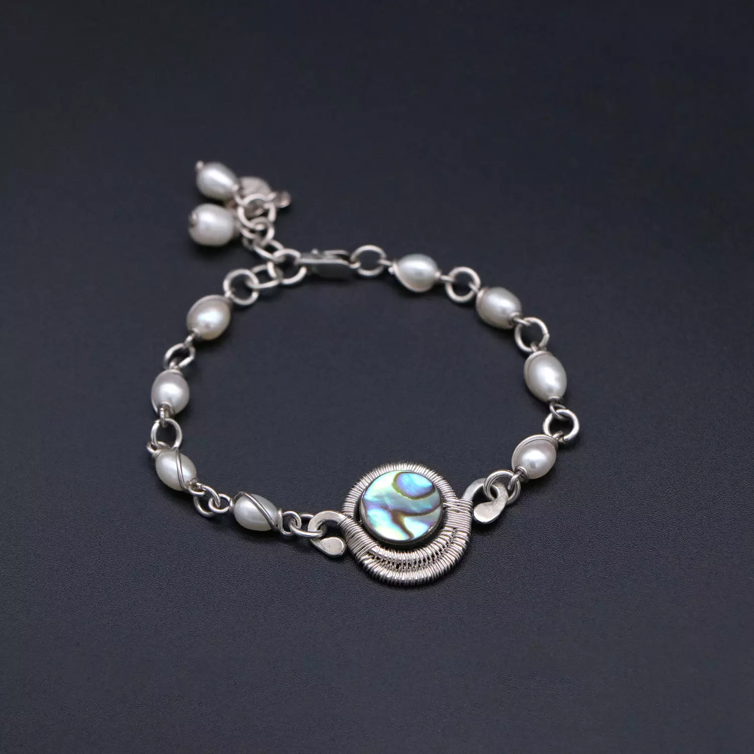 Wire wrapped silver bracelet with with abalone shell and pearls. image