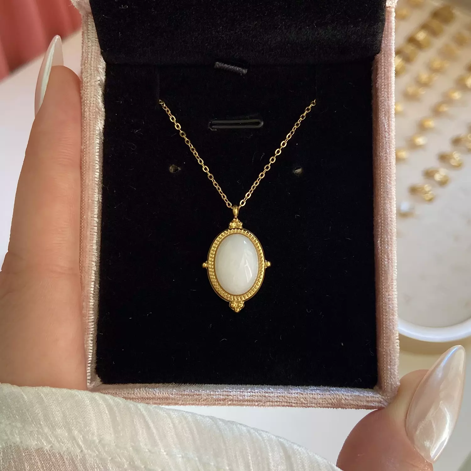 A stainless steel necklace with a white stone in the center, Royal-style  image