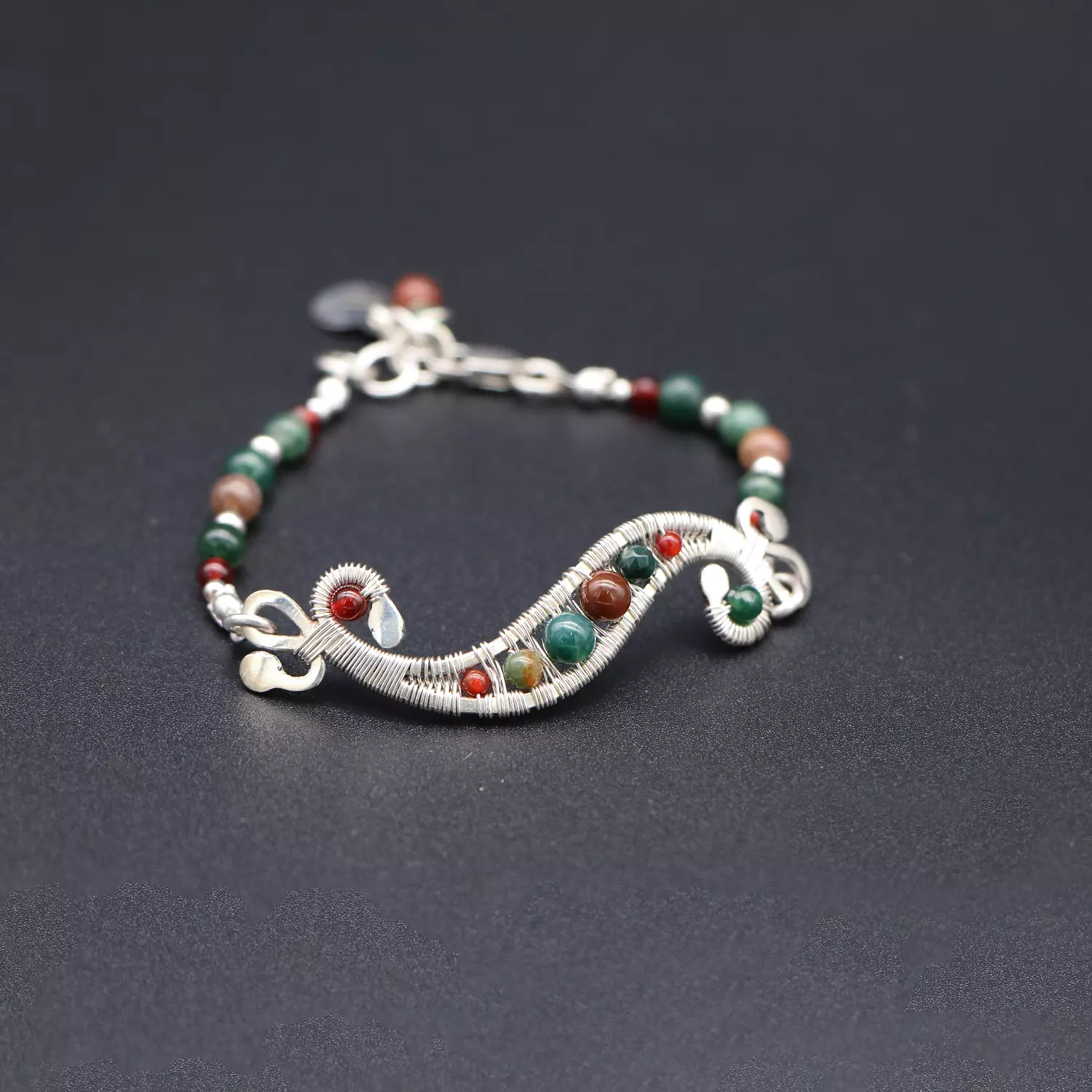 Wire wrapped silver bracelet with moss agate gemstones. image