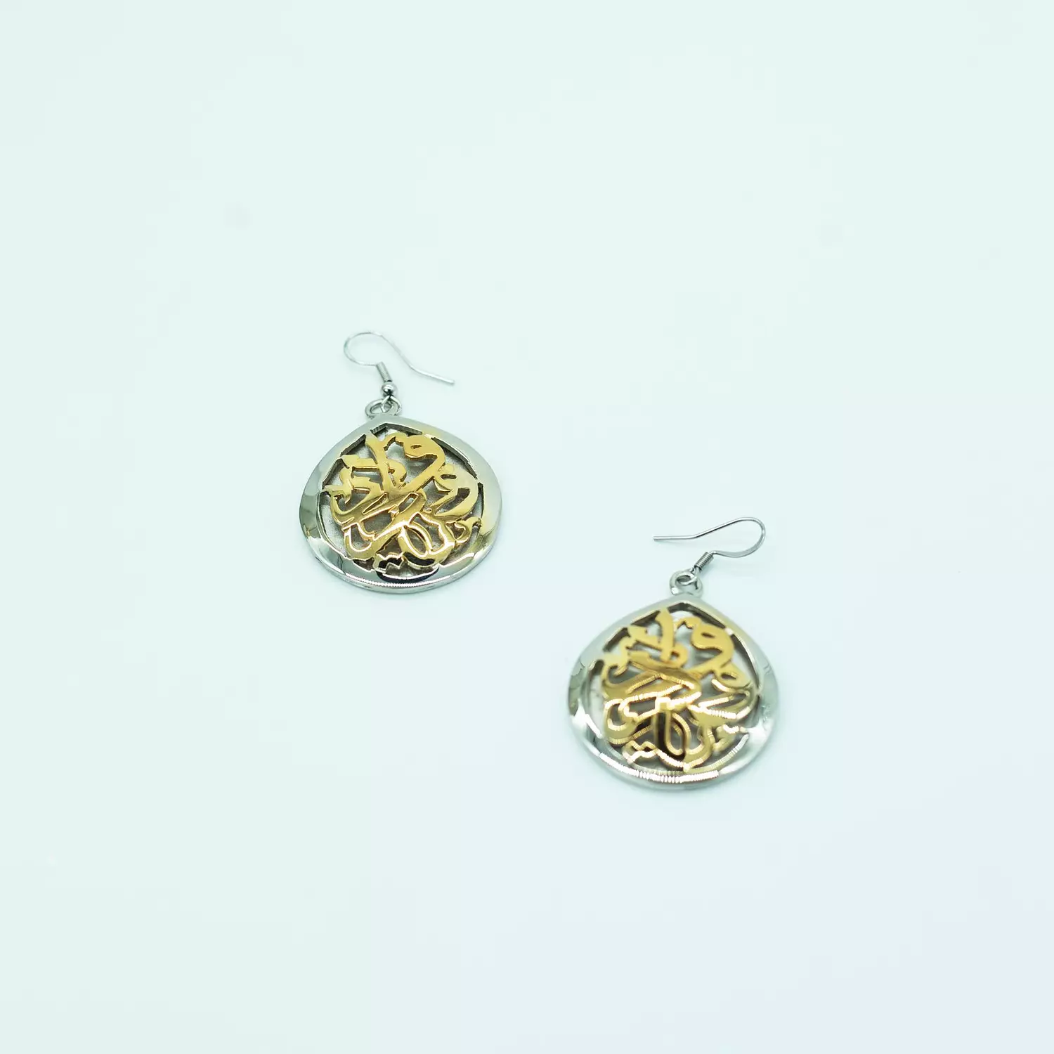 Two-layer copper hoop earrings, curved, sculpted, and plated with matte and shiny gold, silver, and platinum, with a mother-of-pearl stone. image