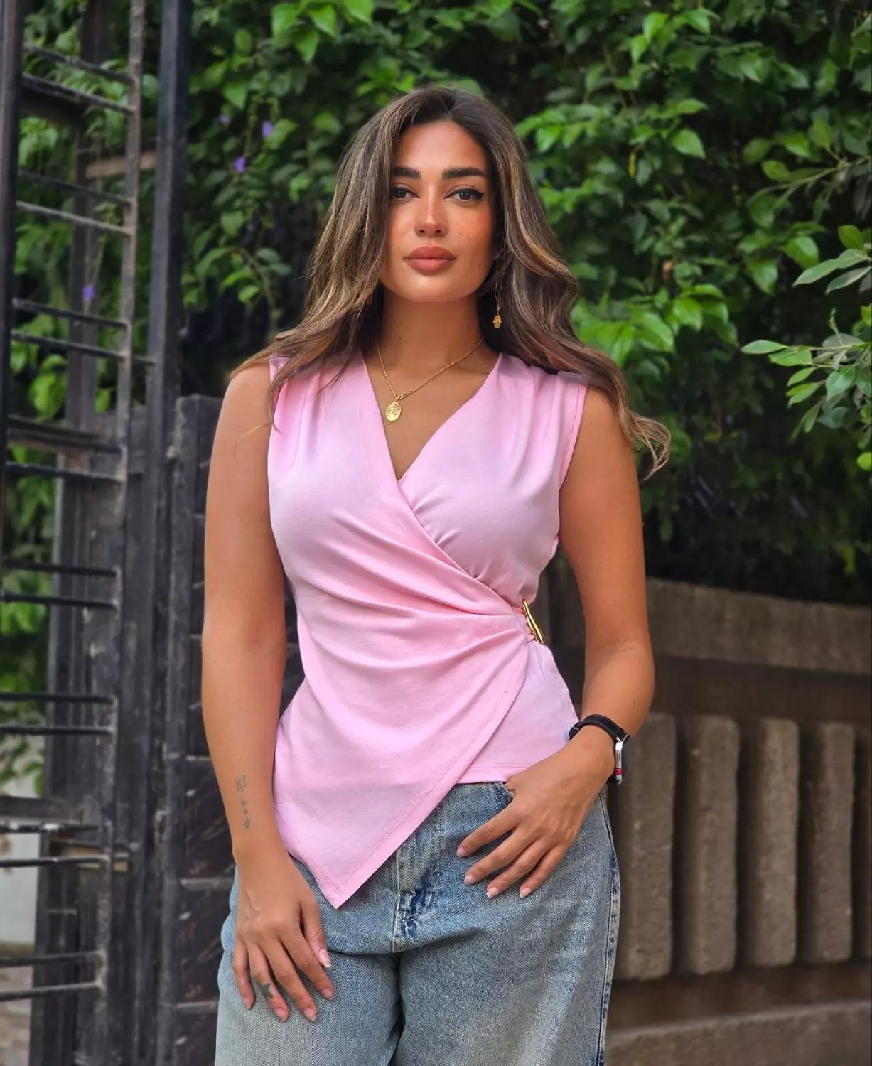 Pink top with gold accessory  image