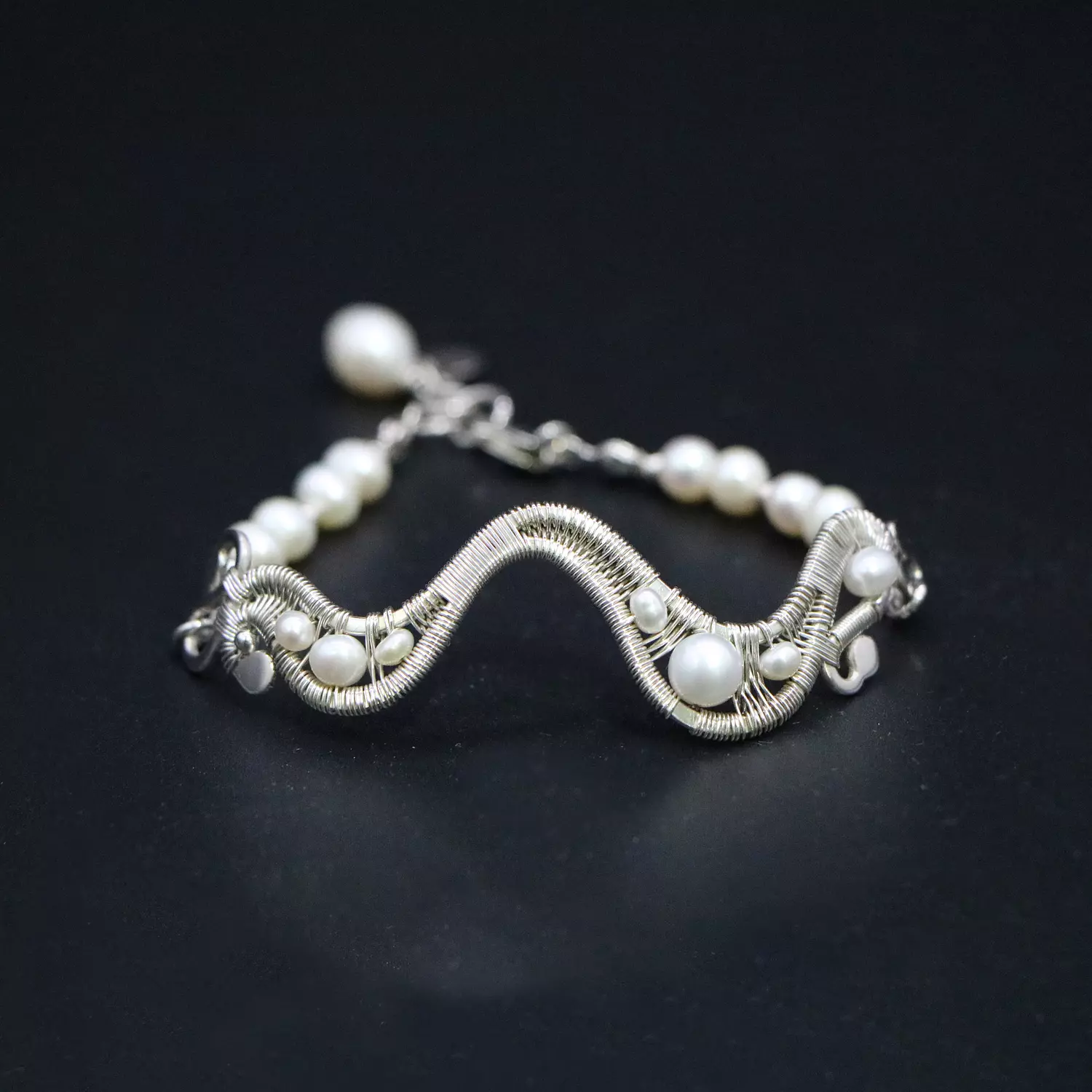 Silver wave bracelet with pearls. image