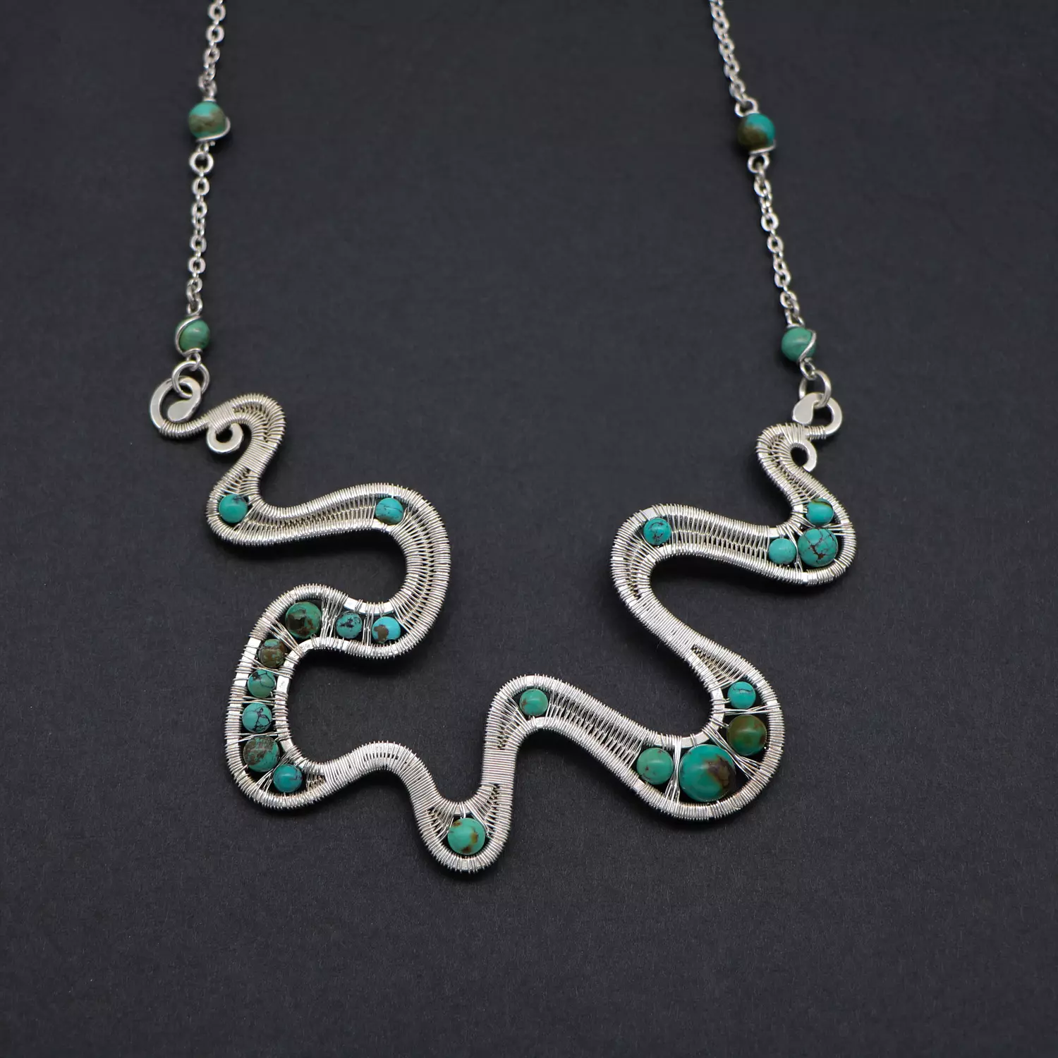 Wire wrapped silver necklace with turquoise gemstones . image