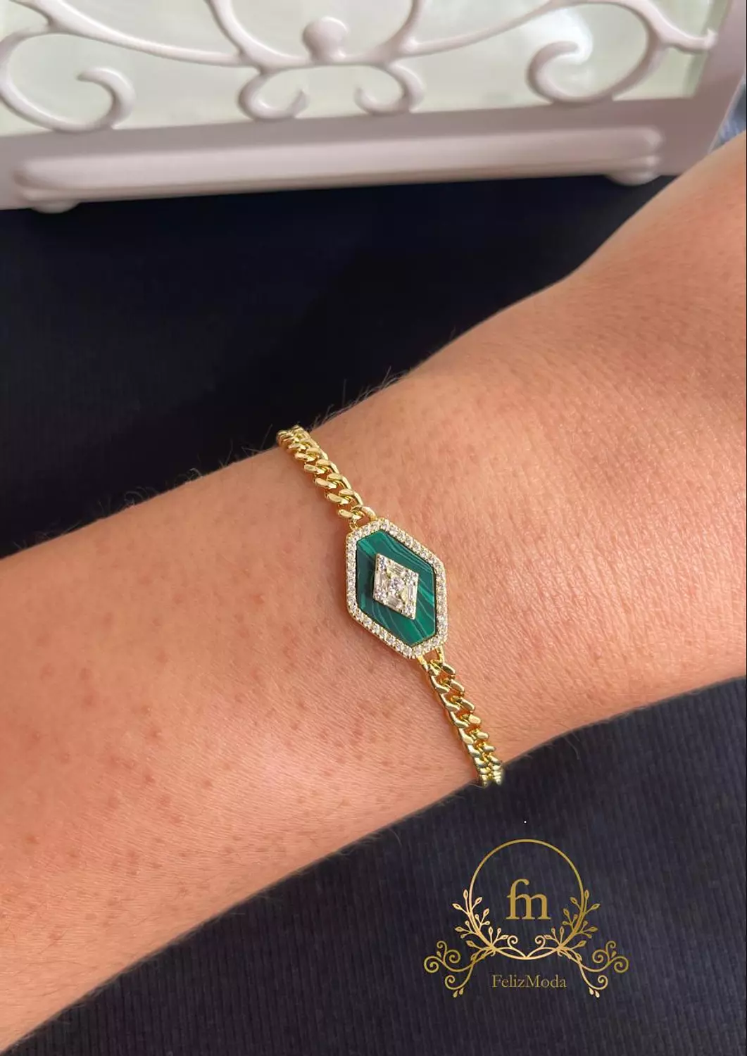 Braided silver bracelet with green stone gold plated image
