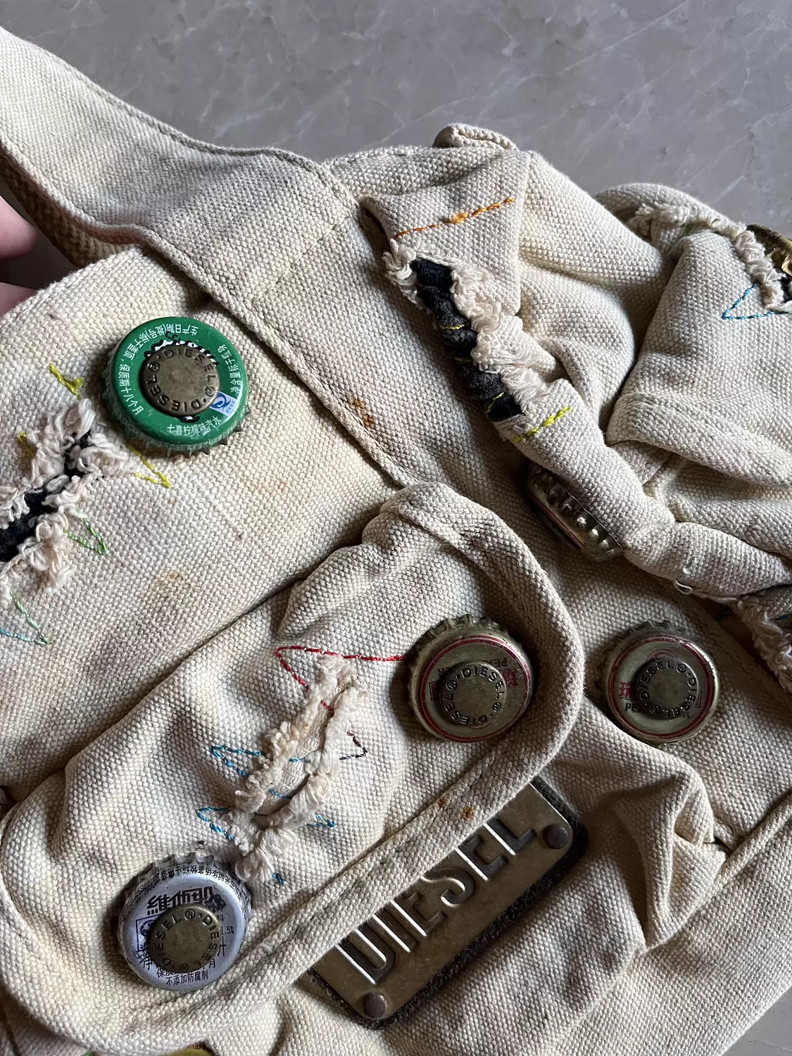 Beige ripped diesel bag with adjustable buttons  3