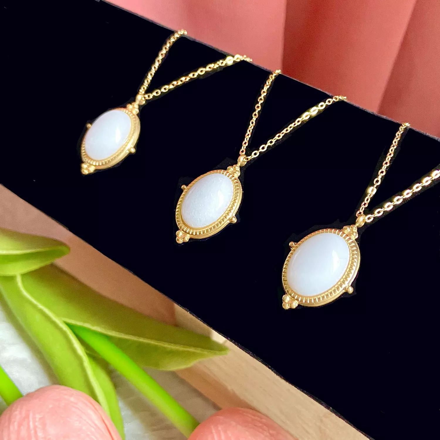 A stainless steel necklace with a white stone in the center, Royal-style  3