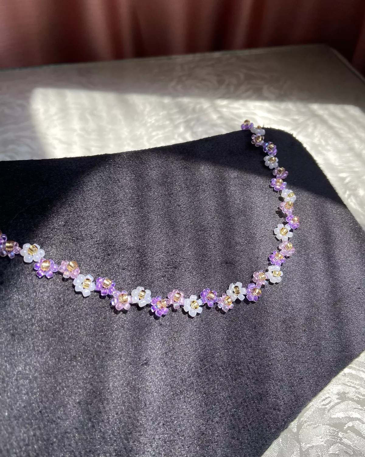 Purple shades with white flowers necklace  1