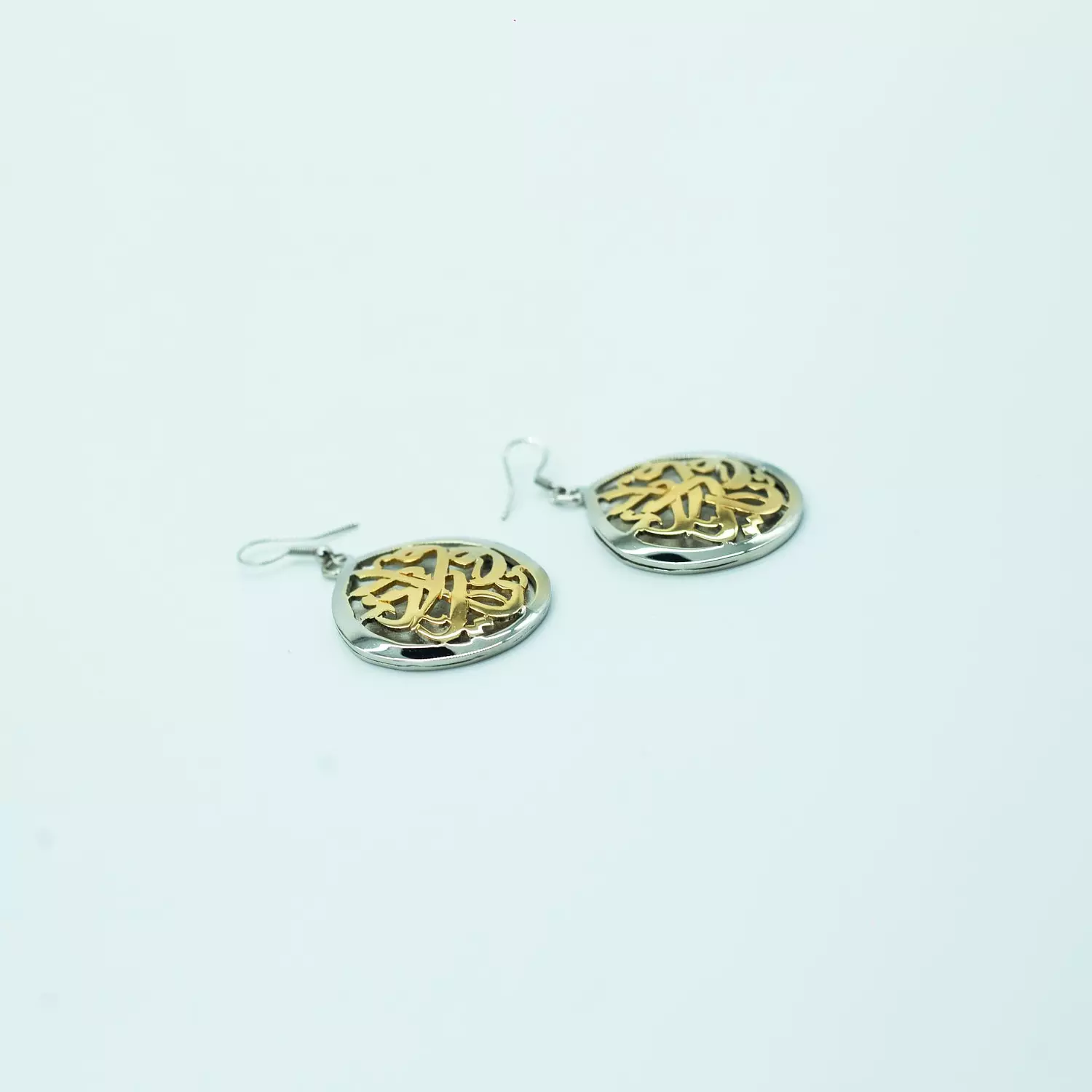 Two-layer copper hoop earrings, curved, sculpted, and plated with matte and shiny gold, silver, and platinum, with a mother-of-pearl stone. hover image