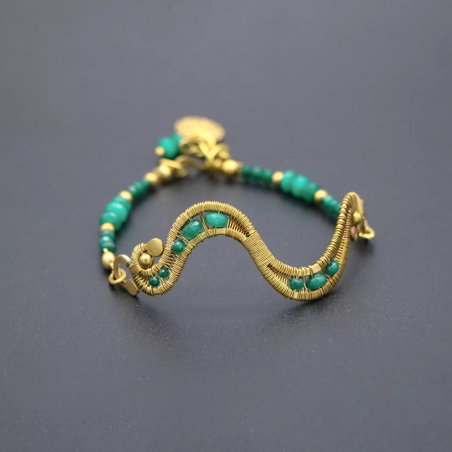 Brass bracelet with green jade stones. image