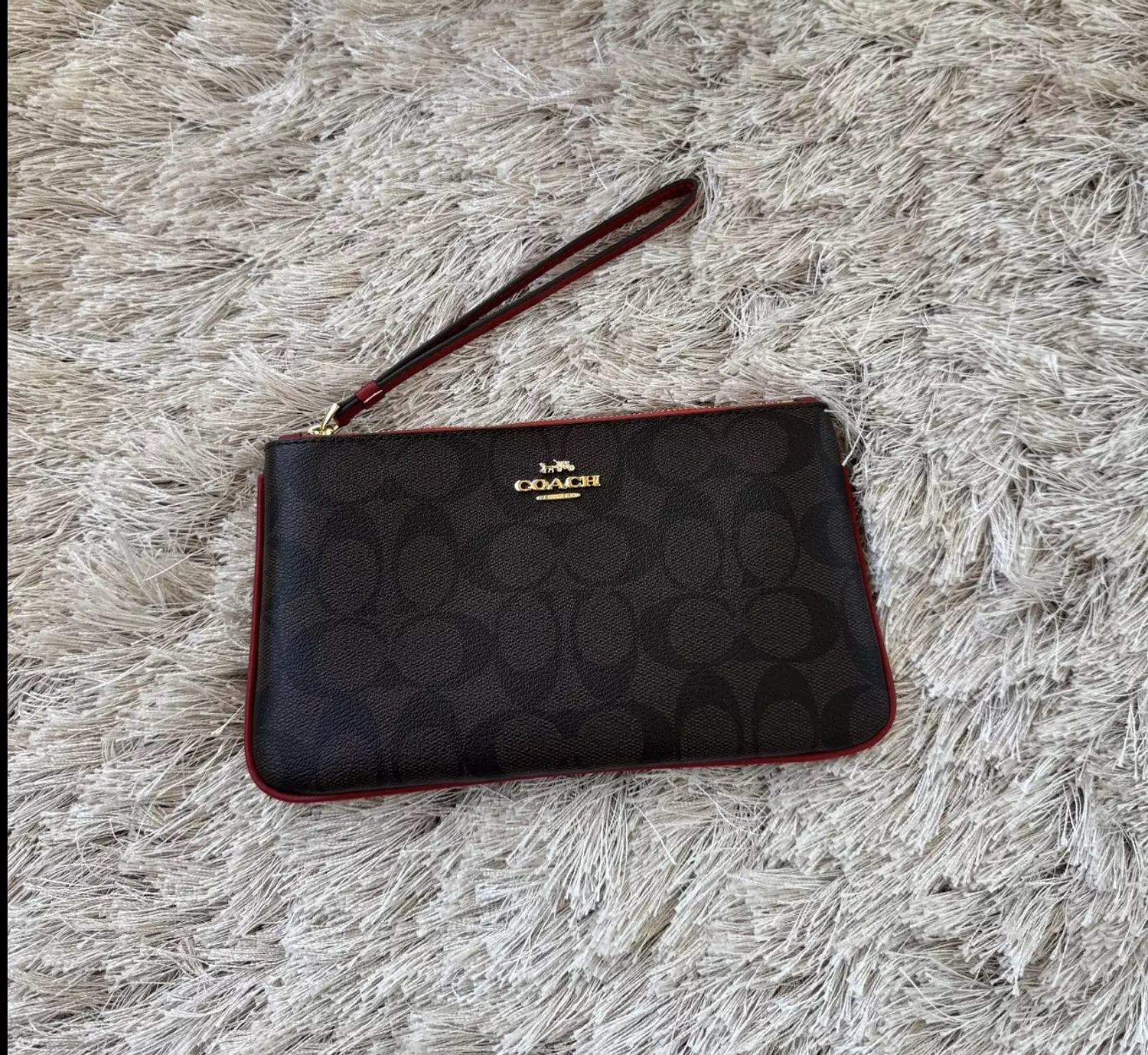 Coach wristlet in signature canvas with red stroke  1