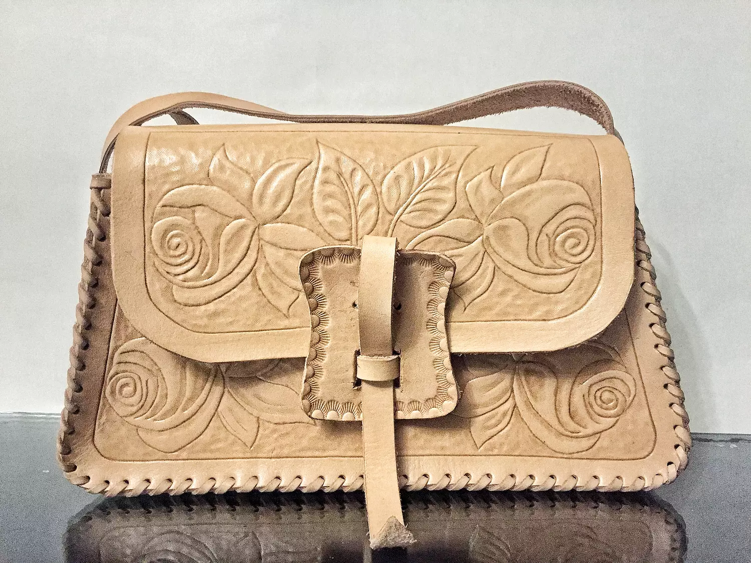 Tooled roses leather shoulder bag with strap closure  hover image