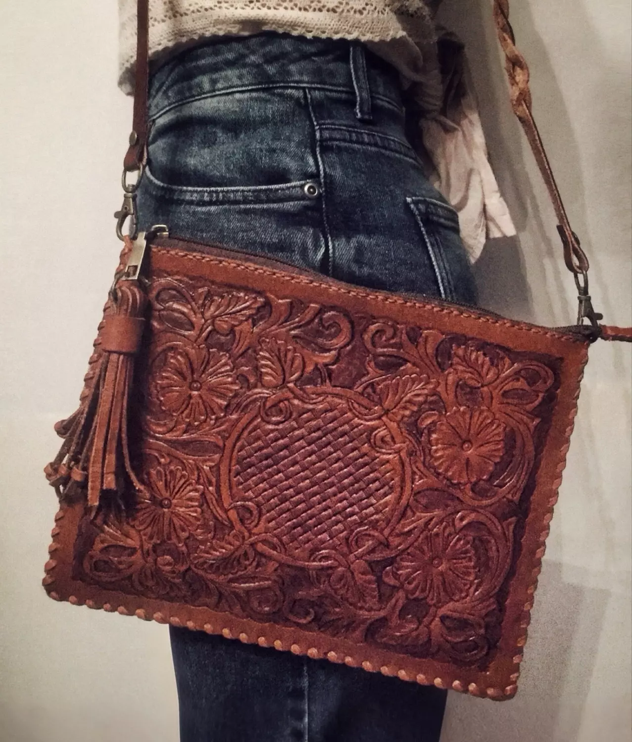 Floral basket tooled leather clutch hover image